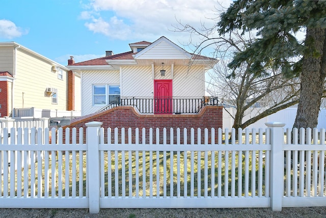 view of front of house with a fenced front yard and a chimney