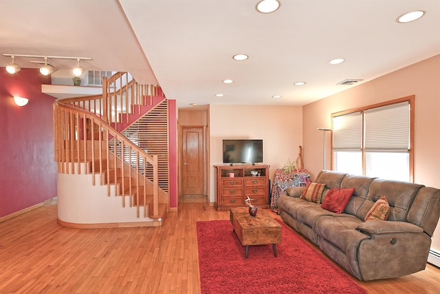 living room featuring light wood-style flooring, stairway, visible vents, and recessed lighting