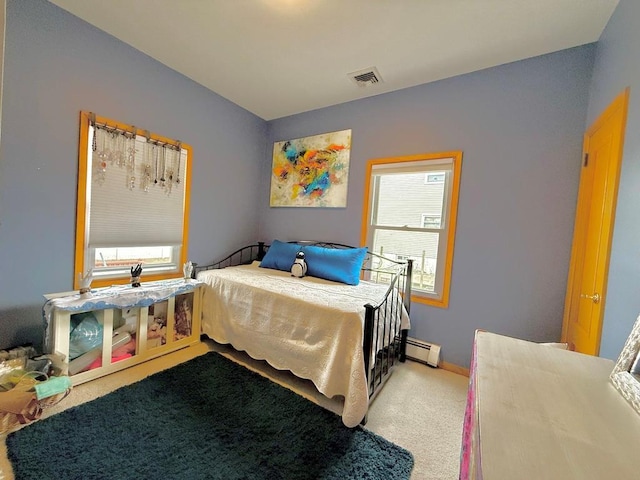 bedroom featuring multiple windows, baseboard heating, visible vents, and light colored carpet