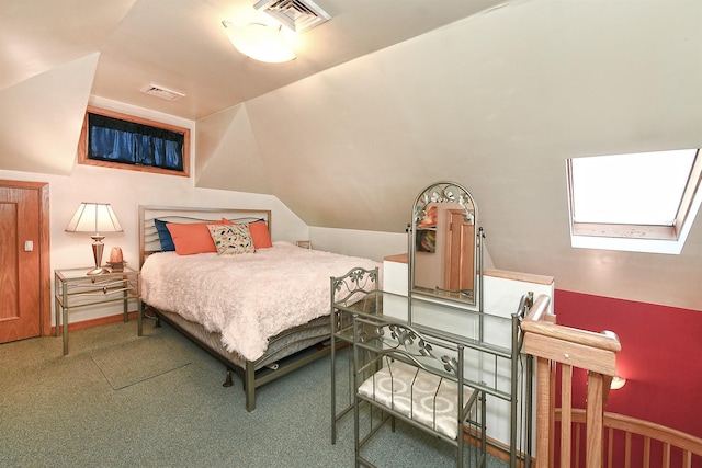 carpeted bedroom featuring lofted ceiling with skylight and visible vents