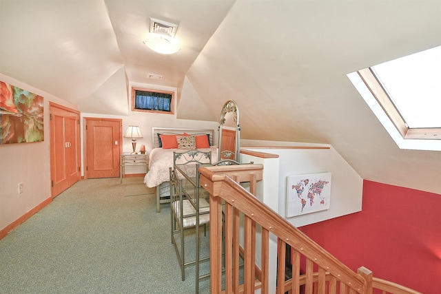 bedroom featuring light carpet, lofted ceiling with skylight, baseboards, and visible vents