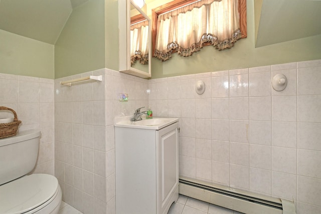 bathroom with tile walls, toilet, baseboard heating, vanity, and tile patterned floors