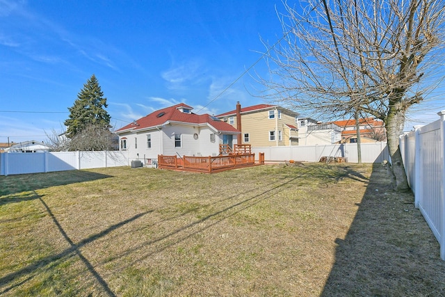 back of house featuring a deck, cooling unit, a fenced backyard, a yard, and a residential view