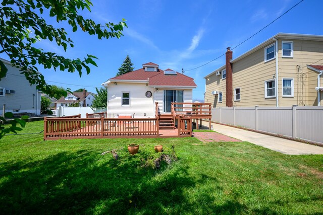 67 Newport Rd, Island Park, NY 11558 - back of property with a deck, a fenced backyard, and roof with shingles