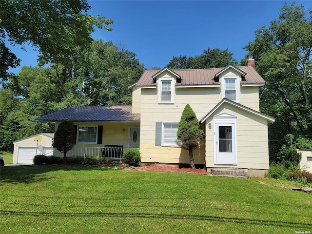 traditional-style home with an outbuilding, metal roof, covered porch, a chimney, and a front yard