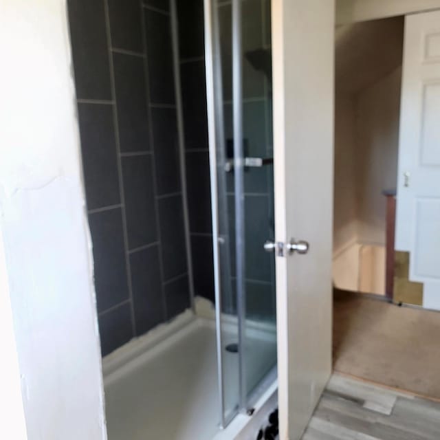 bathroom with a shower with shower door