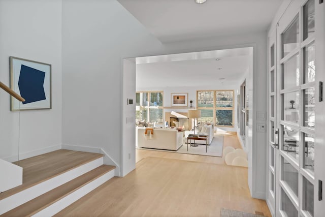 interior space featuring light wood-type flooring and baseboards