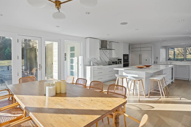 dining room with light wood-style floors and recessed lighting