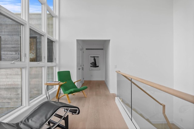 corridor with light wood-style flooring and baseboards