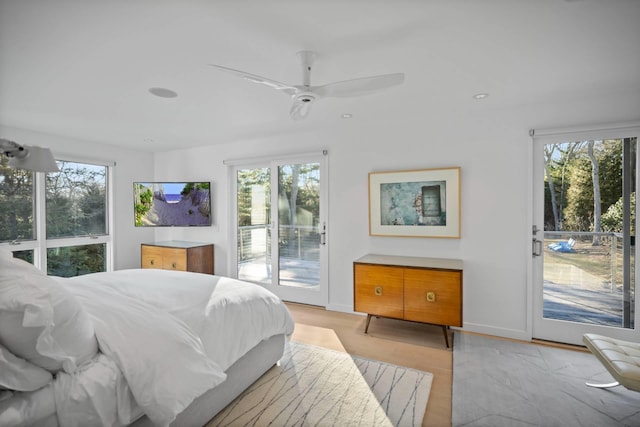 bedroom with ceiling fan, access to outside, multiple windows, and baseboards