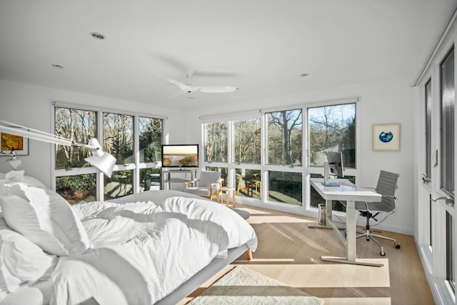 bedroom with light wood-style flooring and baseboards