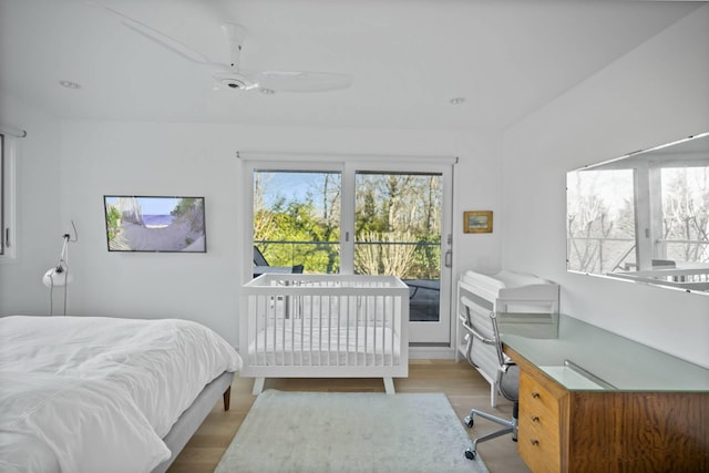 bedroom featuring access to outside, ceiling fan, and light wood-style flooring