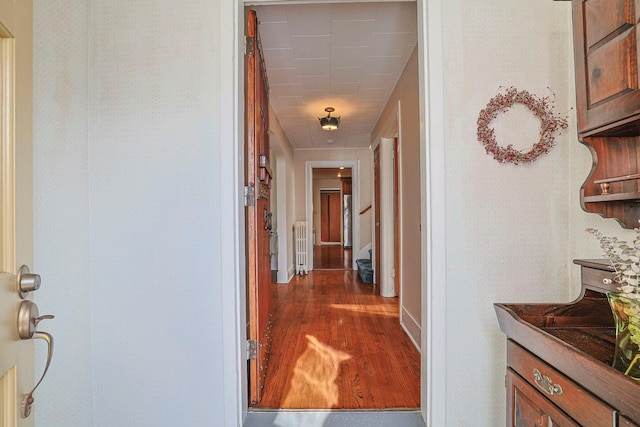 hallway featuring dark wood-style floors and stairs