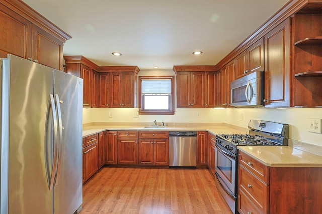 kitchen with light wood-style flooring, appliances with stainless steel finishes, open shelves, a sink, and recessed lighting