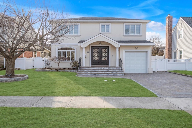 view of front of property with a gate, fence, a front lawn, and stucco siding