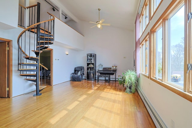 44 Karen Joy Dr, Middletown, NY 10940 - living area featuring a baseboard heating unit, ceiling fan, stairs, wood finished floors, and high vaulted ceiling