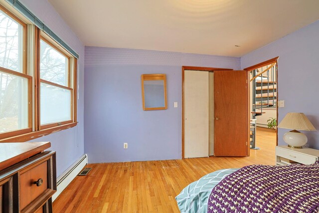 44 Karen Joy Dr, Middletown, NY 10940 - bedroom featuring a baseboard heating unit, wood finished floors, and a closet