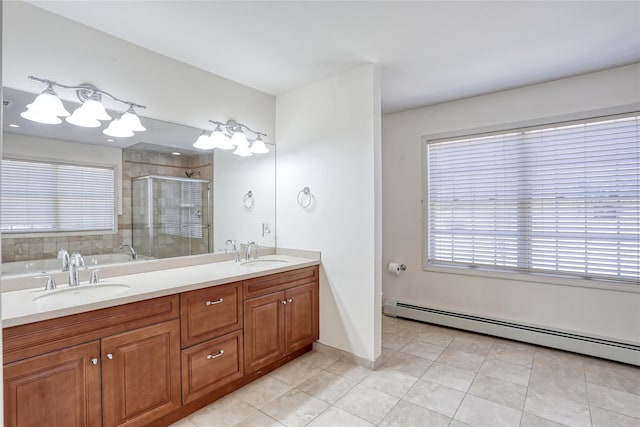 bathroom with a stall shower, a baseboard radiator, a sink, and tile patterned floors