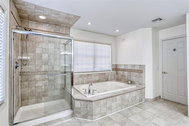 bathroom featuring a stall shower, visible vents, a tub with jets, and tile patterned floors