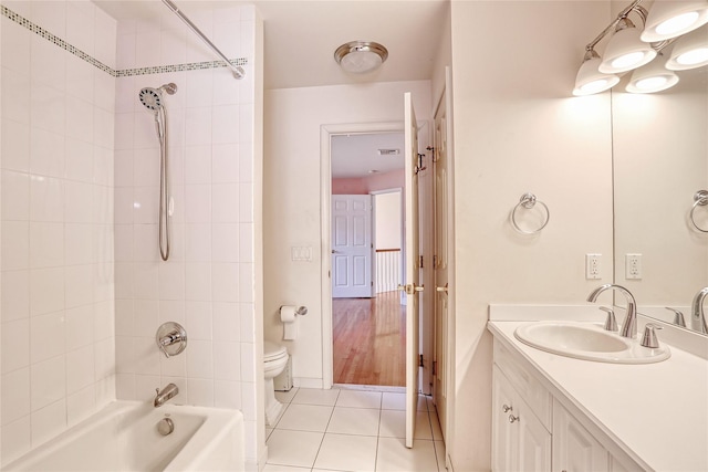 full bath featuring tile patterned flooring, vanity, toilet, and shower / bathtub combination