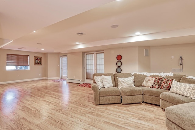 living room with recessed lighting, a baseboard heating unit, visible vents, baseboards, and light wood finished floors