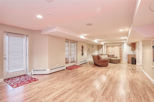 living area with light wood-type flooring, a baseboard radiator, baseboards, and recessed lighting