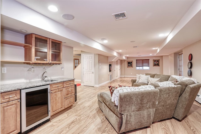 living area with light wood finished floors, baseboards, visible vents, wine cooler, and recessed lighting