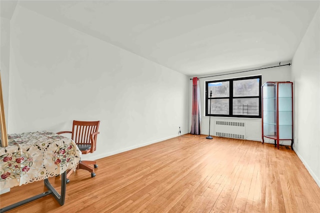 interior space with light wood-style floors, baseboards, and radiator heating unit