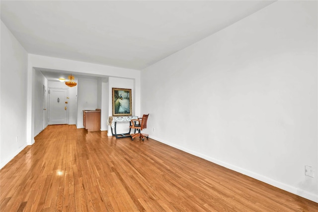 spare room featuring light wood-style flooring and baseboards