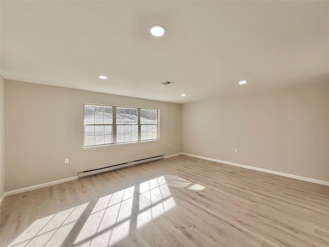 unfurnished room featuring light wood finished floors, a baseboard radiator, recessed lighting, visible vents, and baseboards