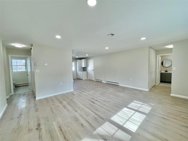 unfurnished living room with light wood-style flooring, visible vents, and recessed lighting