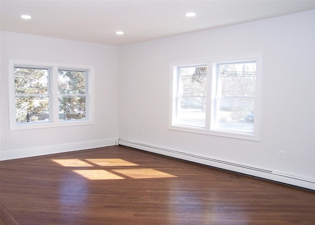 spare room with recessed lighting, dark wood-style flooring, baseboards, and baseboard heating