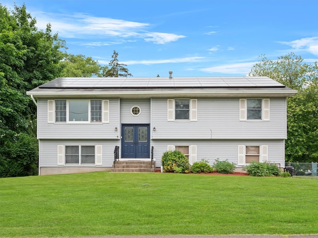 215 Old Haverstraw Rd, Congers, NY 10920 - bi-level home with roof mounted solar panels, a front lawn, and entry steps
