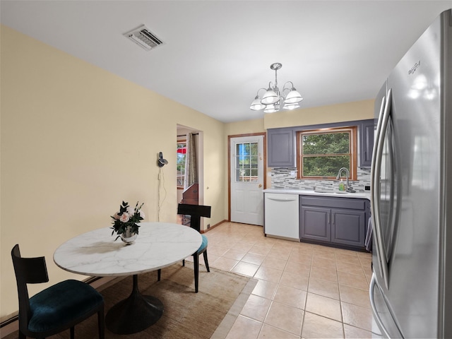 215 Old Haverstraw Rd, Congers, NY 10920 - kitchen featuring freestanding refrigerator, white dishwasher, a chandelier, a sink, and light countertops