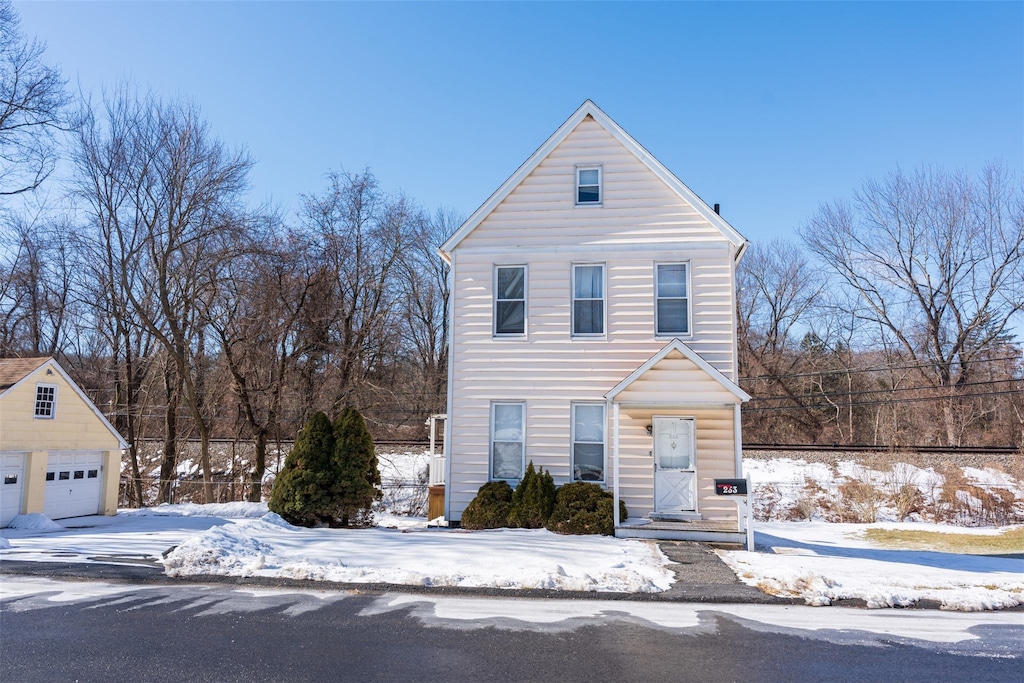 traditional-style home with an outbuilding and a detached garage