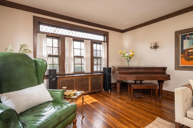 living area featuring dark wood-style floors, baseboards, ornamental molding, and radiator heating unit