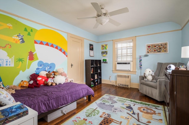 bedroom with ceiling fan, cooling unit, dark wood-type flooring, baseboards, and radiator