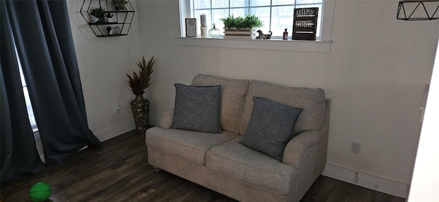 sitting room featuring dark wood-type flooring and baseboards