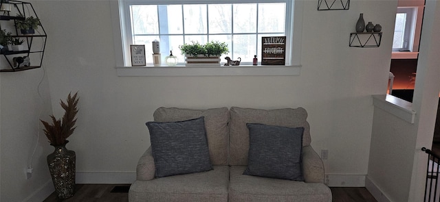 living area featuring wood finished floors and baseboards