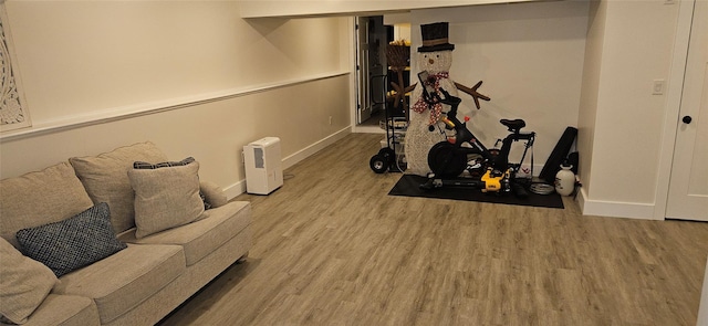 exercise area featuring light wood-style floors and baseboards