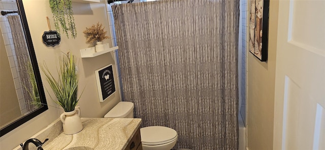 bathroom featuring curtained shower, vanity, and toilet