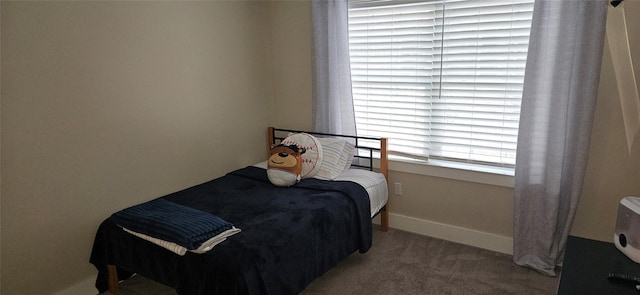 bedroom featuring carpet and baseboards