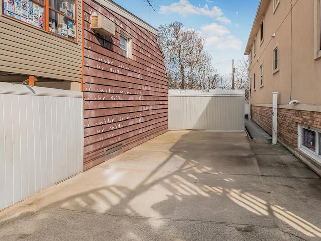 view of patio with an AC wall unit