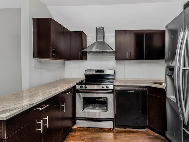 kitchen with stainless steel appliances, light countertops, wall chimney exhaust hood, and dark wood-style floors