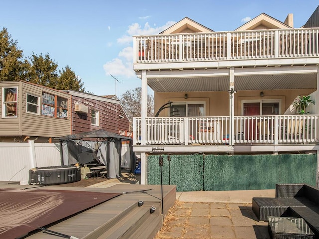 exterior space with fence, a balcony, a gazebo, and a patio