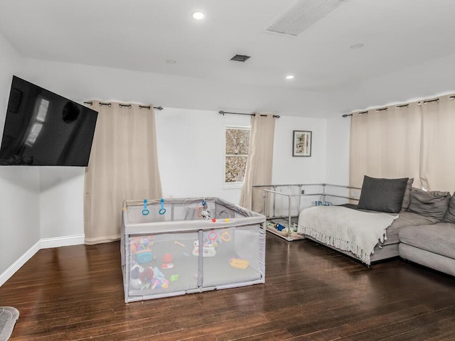 bedroom with recessed lighting, wood finished floors, and baseboards