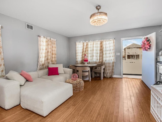 living area featuring hardwood / wood-style floors and visible vents