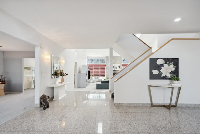 entryway with recessed lighting, granite finish floor, and baseboards