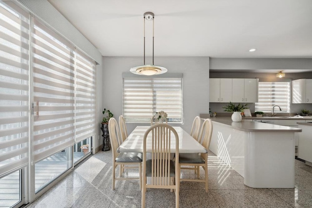 dining space featuring a healthy amount of sunlight, granite finish floor, and recessed lighting