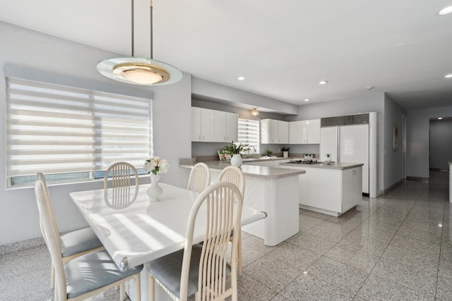 dining room featuring recessed lighting, granite finish floor, and baseboards